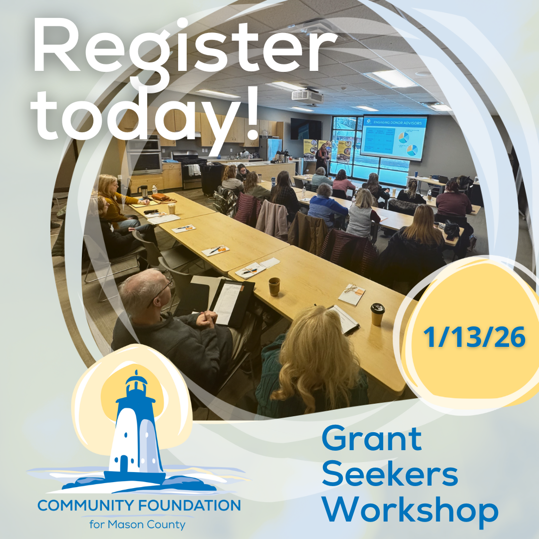 A group of people sit at tables in a classroom, watching a presentation on screens. Text reads: “Register today! 1/13/26 Grant Seekers Workshop.” Community Foundation for Mason County logo with a lighthouse is visible.